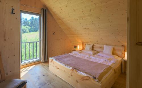 a bed in a room with a large window at Villa Elisabeth in Ratsch an der Weinstraße