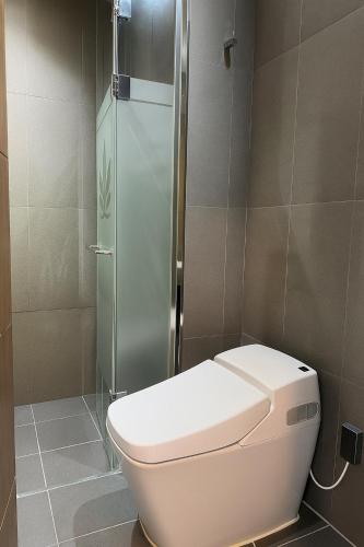 a bathroom with a toilet and a glass shower at 웨스턴인터내셔널호텔 in Incheon