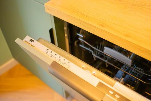 a remote control sitting on top of an oven at Parking gratuit à 3 min à pied, Clim, Laverie, Fibre, proche de Rousset, zone d'activités et domaines pour Mariages in Trets