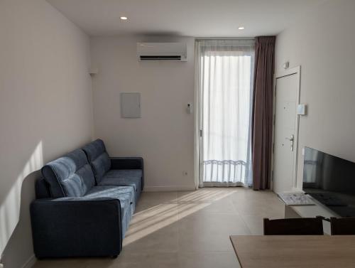 a living room with a couch and a television at Cal Ticó, 6 guests Monistrol de Montserrat in Monistrol