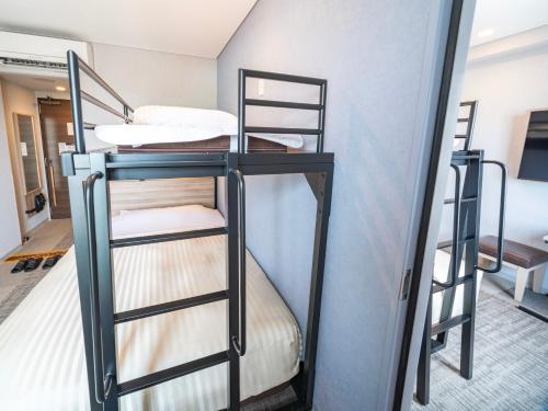 a bunk bed in a room with two bunk beds at Super Hotel Shiga Nagahama Tennen Onsen in Nagahama
