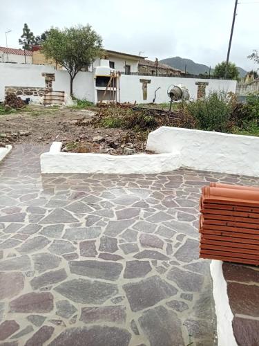 a bench sitting on a stone patio with snow at B&B ANNA in Piscinas