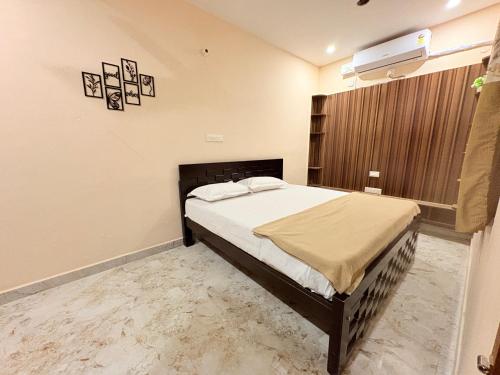 a bedroom with a large bed in a room at Happy Madurai Home stay in Madurai