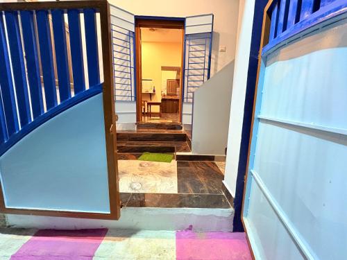 a door leading to a hallway with colorful floors at Happy Madurai Home stay in Madurai