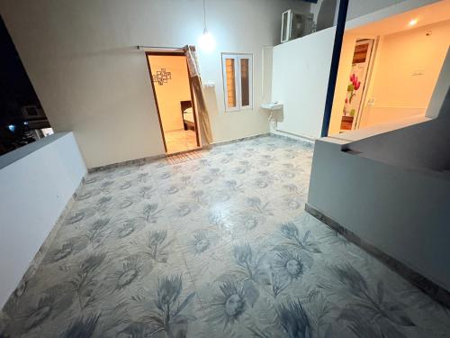 an empty room with a flower patterned floor at Happy Madurai Home stay in Madurai