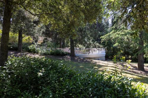 a bench in a park with trees and grass at Villa Rinaldi in Montespertoli