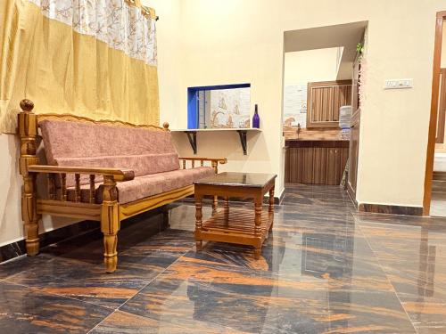 a living room with a couch and a table at Happy Madurai Home stay in Madurai