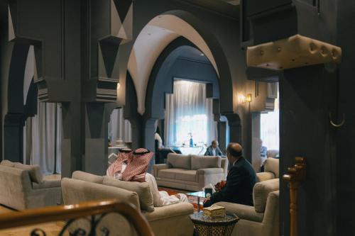 a couple of people sitting in a living room at RS Hotel Karam Palace in Ouarzazate