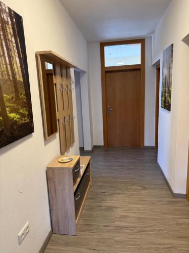 a corridor of a room with a door and a wooden floor at Silent City Apartments in Walddorf