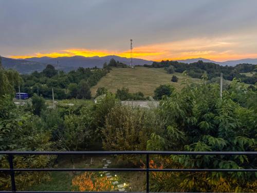 a view of a hill with the sunset in the background at Sunset Hills Chalet in Slănic