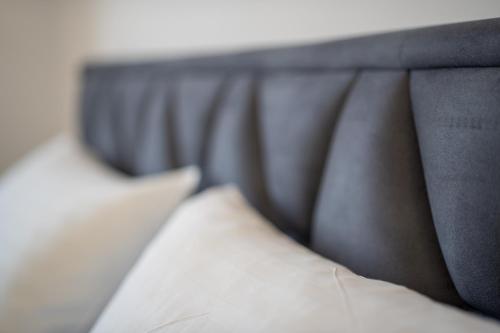 a close up of a bed with a pillow at Poolside Hideout Apartments in Novalja
