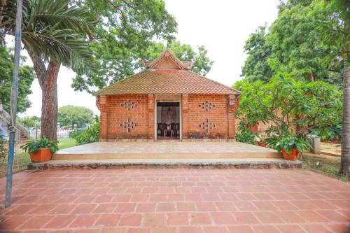 a brick building with a pavilion in a park at YMCA International Youth Programme Centre & Guest house in Kovakulam