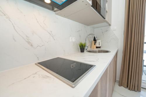 a kitchen with white marble countertops and a sink at Poolside Hideout Apartments in Novalja