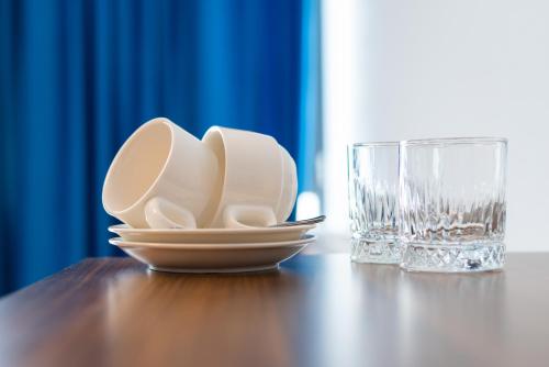 a plate and a glass on a wooden table at Gori Apartments in Gori