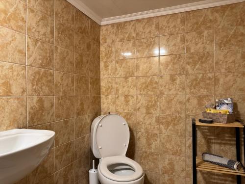 a bathroom with a toilet and a sink at Katoi - Traditional House in Panayia