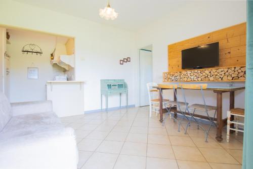 a living room with a kitchen and a table with chairs at breathtaking lake view and pool, Prato Verde in Barcuzzi