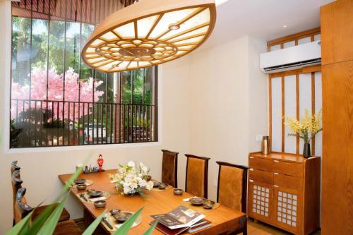 a dining room with a table and a chandelier at Pearl River Hotel in Hai Phong