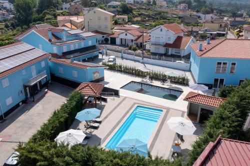 an aerial view of a house with a swimming pool at Villa Montês - Exclusive Apartments & Prime Location in Coja
