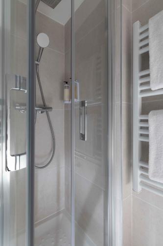a shower with a glass door in a bathroom at Seb & Co in Paris