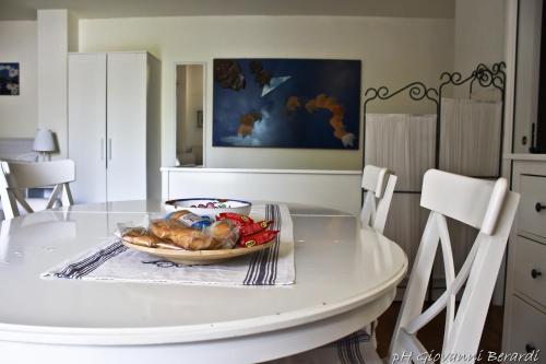 a white table with a bowl of food on it at Albarosa in Ruvo di Puglia