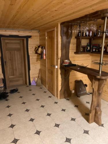 a room with a table in a log cabin at Карпатский Рай in Yaremche