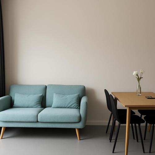 a blue couch in a room with a table at Talle-Central Apartment Odense C in Odense