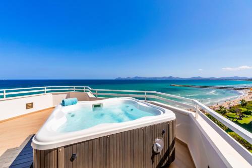 a hot tub on the balcony of a cruise ship at Playa Esperanza Resort Affiliated by Meliá in Playa de Muro