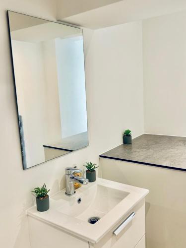a bathroom with a white sink and a mirror at Folkestone Harbour - 3 Bed sleeps 7 Ground Floor in Dover