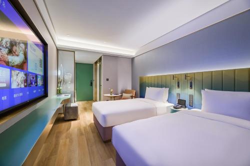 Postelja oz. postelje v sobi nastanitve Shanghai Hongqiao Airport National Exhibition Center Manxin Hotel