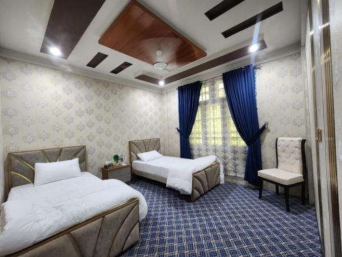 Ένα ή περισσότερα κρεβάτια σε δωμάτιο στο Dream Palace Hotel Rakaposhi Nagar
