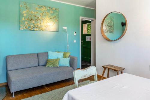 a living room with a couch and a mirror at Der Flusshof, Scheunenwohnung in Werben
