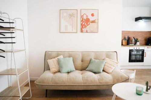 - un salon avec un canapé et des oreillers dans l'établissement Studio tout confort - En plein centre de Lorient, à Lorient