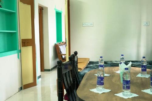 a table with bottles of water on top of it at Red Paradise in Vālpārai