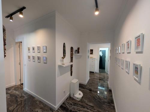 a room with white walls and pictures on the walls at Penthouse NIKOLA in Budva