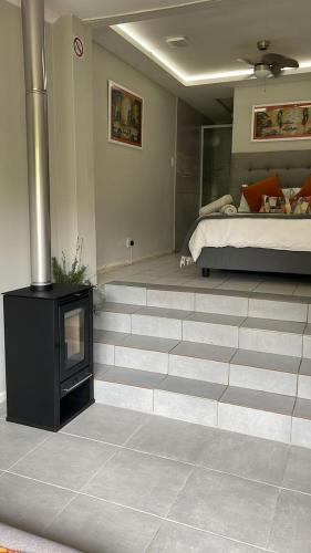 a room with a bed and a television on a floor at Footprints Self Catering Indoor Heated Pool and Fireplaces in Lanseria