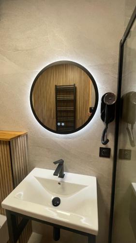 a bathroom with a sink and a mirror at Apartament u Jagi Sądelska 119f in Murzasichle