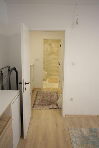 a room with a hallway with a bathroom and a door at Apartman Centar in Fojnica