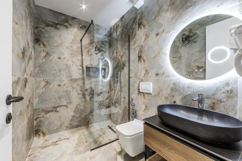 a bathroom with a black sink and a mirror at Zoe's Villa by PS in Durrës