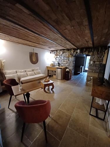 a living room with a couch and a table at Hébergement insolite avec jacuzzi privatif Millau in Millau