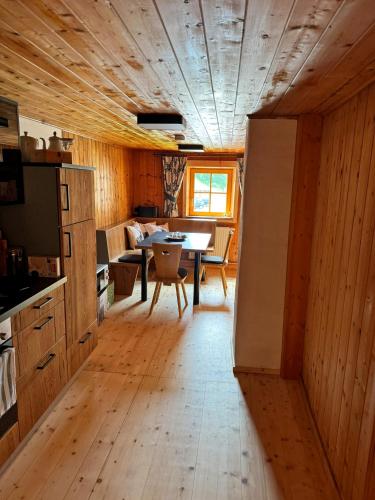a kitchen and dining room with a table and a refrigerator at ZumHubertus in Bschlabs