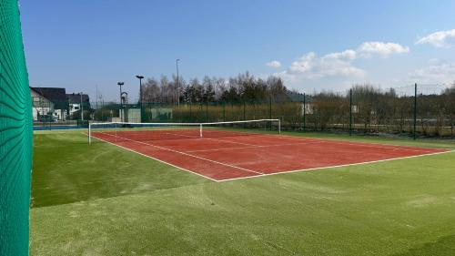 a tennis court with a net on top of it at Grand Łeba - Adults Only (13+) in Łeba