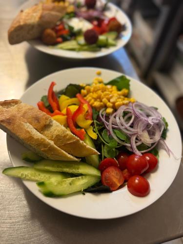 two plates of food on a table with a salad at Boga's im Schützenhof Hüttenbusch in Worpswede