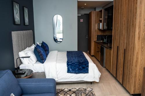 a bedroom with a bed and a blue wall at Triple M Luxury in Vosburg