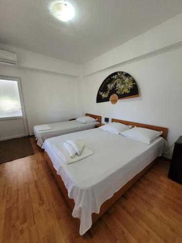 a bedroom with two beds and a window at Vila Didi, Mangalia in Mangalia