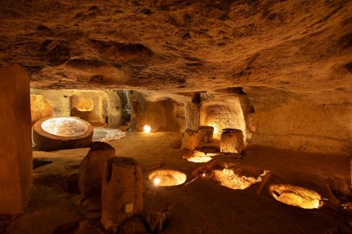 a cave with a room with fires in it at Borgo Mulino a Vento - Resort in Uggiano la Chiesa