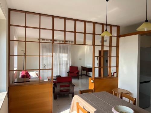 a kitchen and living room with a large glass wall at Terrazza Idrusa in Otranto