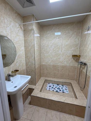 a bathroom with a shower and a sink at Tara Lodge in Ulaanbaatar