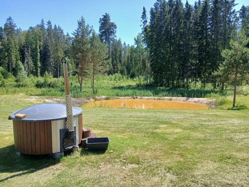 a hot tub sitting in the middle of a field at Nature Reserve Hideaway 