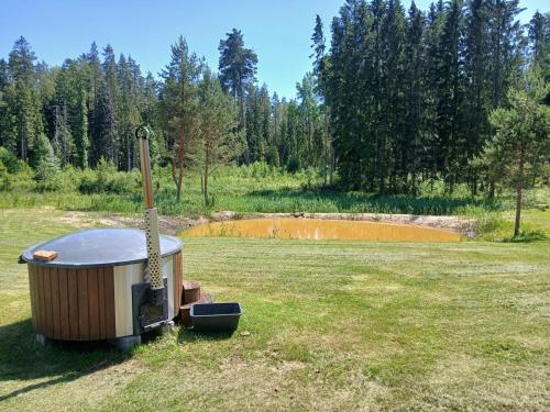 a hot tub sitting in the middle of a field at Nature Reserve Hideaway 