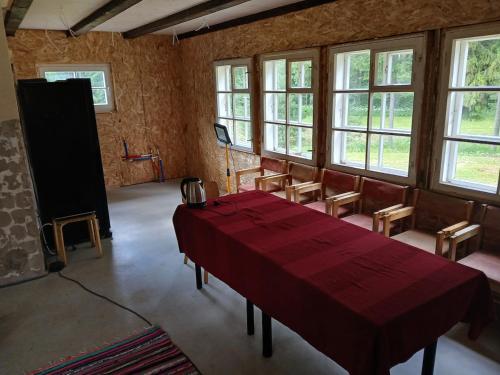 a room with a table and chairs and windows at Nature Reserve Hideaway 